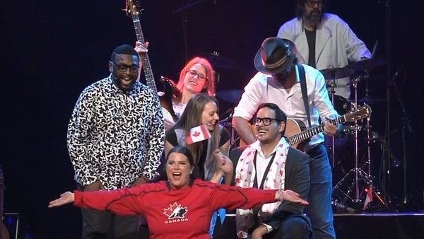 The Canadiana cast on stage at the Greg Frewin Theatre, a singer in a Canada sweater with the band behind her