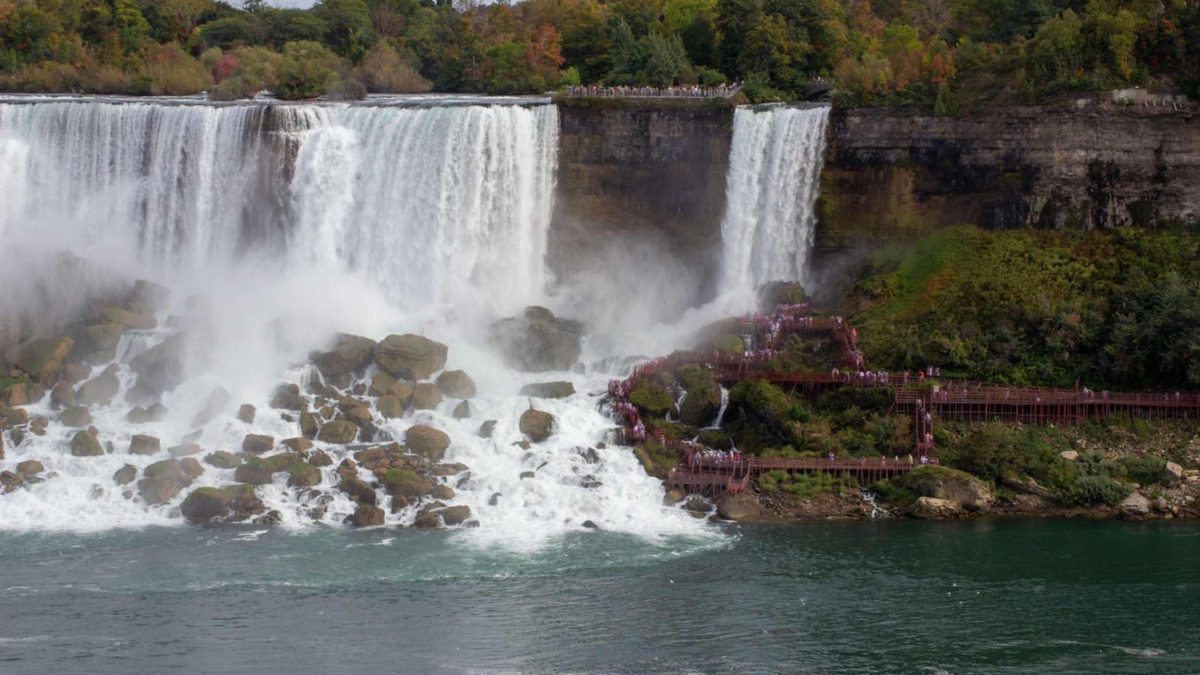 The Cave of the Winds wooden walkways on the rocks beside Bridal Veil Falls, with the American Falls alongside