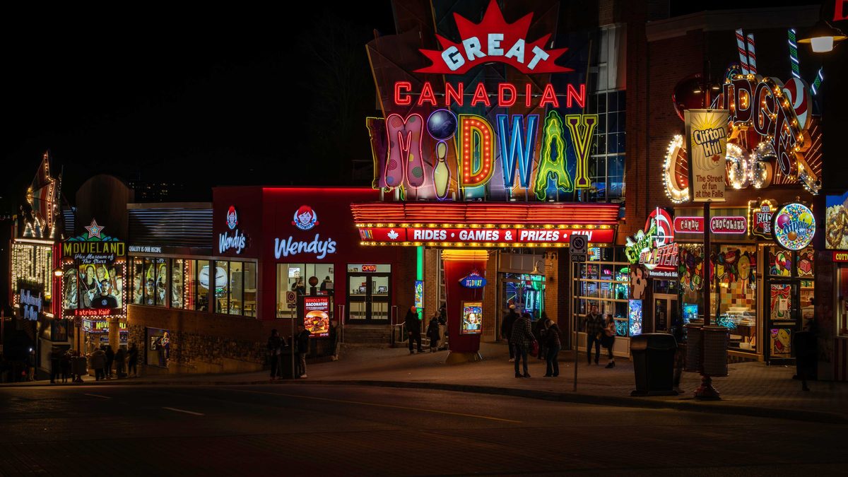 The Great Canadian Midway entrance lit up at night on Clifton Hill