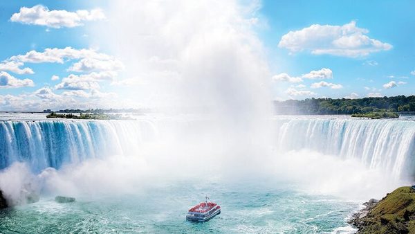 The Horseshoe Falls from above with a Niagara City Cruises boat in the basin below