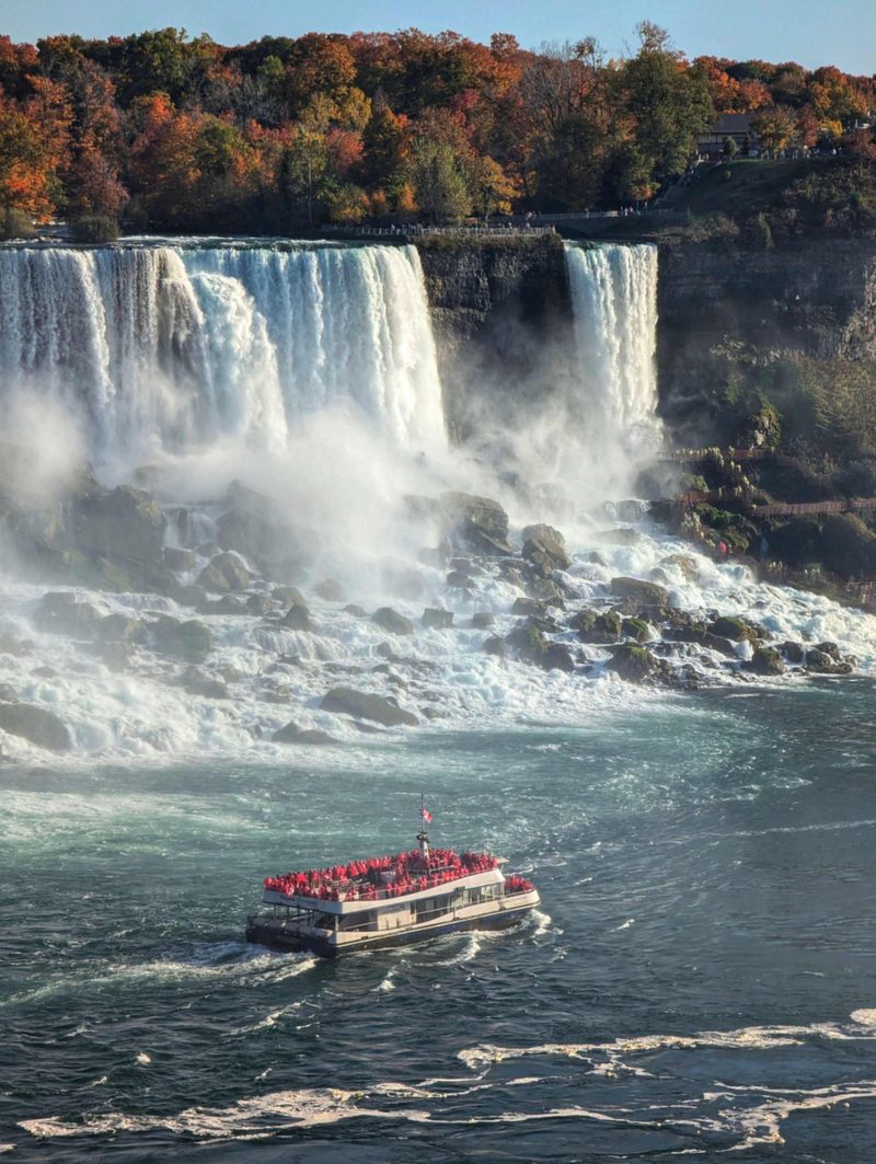 Niagara City Cruises red poncho boat approaching Horseshoe Falls Canada