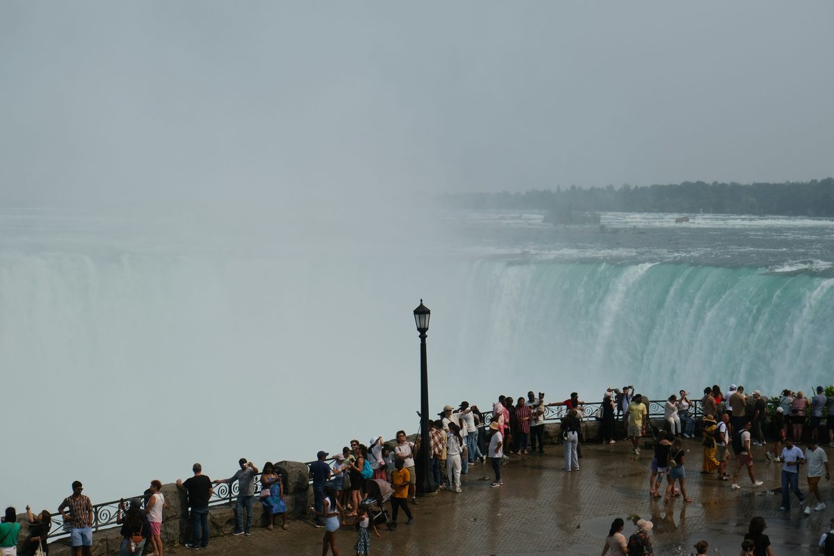 The crest of Horseshoe Falls with mist rising from the basin below, seen from the Canadian rim