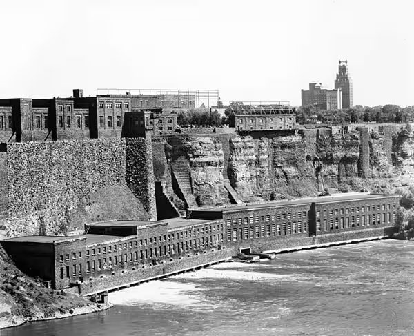 The Schoellkopf stations from downriver, with the Niagara Falls, New York skyline on the gorge rim behind