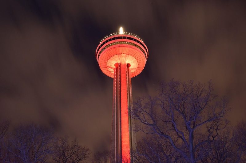The Skylon Tower lit red at night above Niagara Falls, Ontario