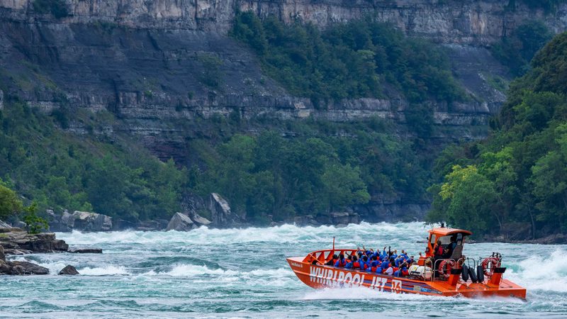 An orange Whirlpool Jet boat in the Niagara Gorge