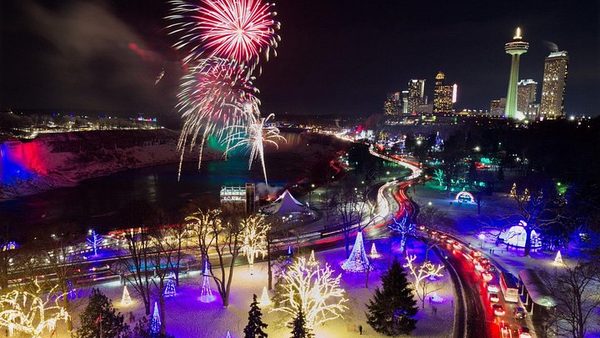 Fireworks over the illuminated park and the Niagara skyline during the Winter Festival of Lights