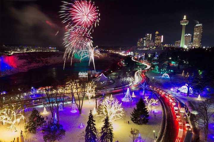 Fireworks over the illuminated Winter Festival of Lights displays in Queen Victoria Park, with the Skylon Tower lit behind